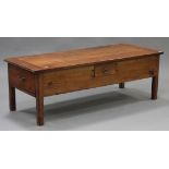 A 20th century French cherry wood coffee table, the rectangular top above two end drawers and a