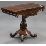 An early Victorian rosewood fold-over card table, the hinged top above a carved foliate frieze,