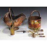 A Victorian copper coal scuttle of helmet form, a copper coal bucket with horizontal brass straps, a