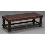 A 20th century Peruvian oak and embossed brown leather occasional table, the rectangular top