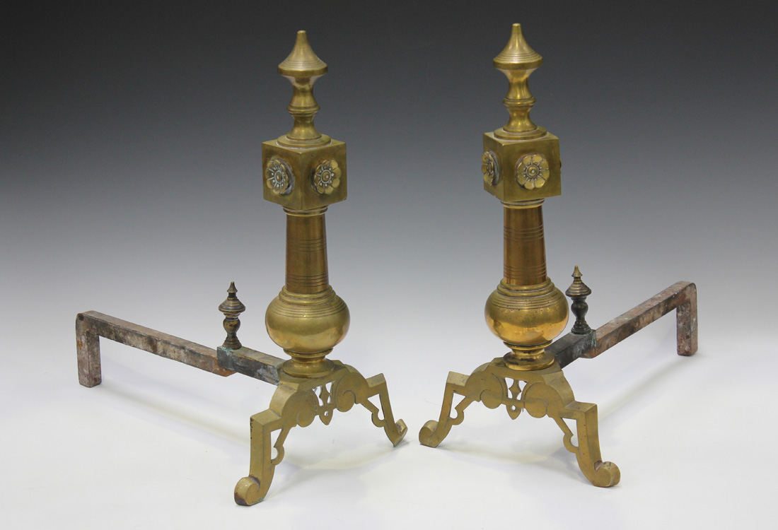 A pair of late Victorian cast brass andirons, the front uprights with turned finials and