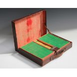 An early 20th century green and ivory-toned celluloid Mahjong set, within a leather case, together