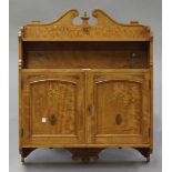 An Edwardian satinwood hanging wall cabinet with ribbon and swag inlaid decoration, the scroll