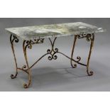 An early 20th century wrought iron garden table, the rectangular white marble top raised on