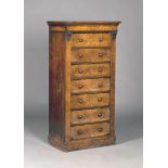 A mid-Victorian figured mahogany Wellington chest of seven drawers, fitted with turned bun