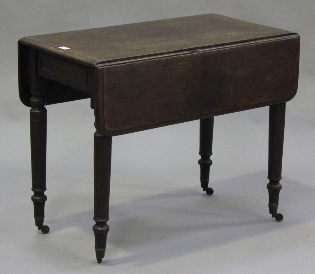 A mid-Victorian mahogany Pembroke table, fitted with a single drawer, on turned legs with brass