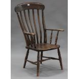 A 20th century beech and elm bar back Windsor armchair, on turned legs united by stretchers,