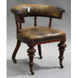 A mid-Victorian oak framed tub back desk chair, upholstered in tan leather, the curved back and seat