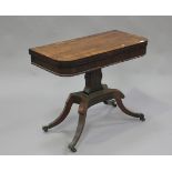 A Regency rosewood fold-over card table with brass line inlaid and crossbanded decoration, raised on