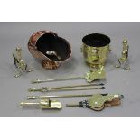 A pair of Edwardian brass fire dogs, a set of three brass fire tools, a brass coal bucket, a