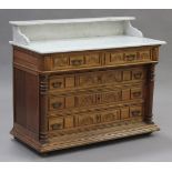An early 20th century French oak washstand, the galleried white marble top above two short and three