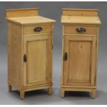 A pair of early 20th century pine bedside cabinets, each fitted with a drawer and a panelled door,