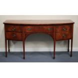 A George III mahogany bowfront sideboard with boxwood stringing, fitted with a cellaret drawer and