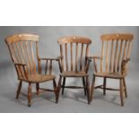 A group of three late 19th/early 20th century beech and elm comb back armchairs.Buyer’s Premium 29.