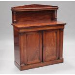 An early Victorian flame mahogany chiffonier, the arched gallery and shelf back on carved