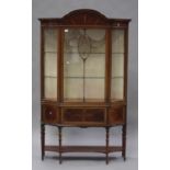 An early 20th century mahogany breakfront glazed display cabinet by Waring & Gillow Ltd, inlaid with