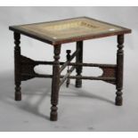 A 19th century Middle Eastern hardwood and brass tray-top table, the inset brass top engraved with