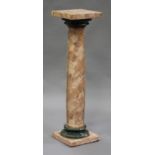 An early/mid-20th century pink marble pedestal, the square top above a turned column with a green