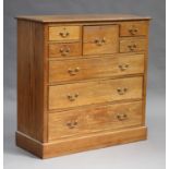 An early 20th century oak chest of five short and three long drawers, raised on a plinth base,