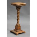 An early 20th century oak plant stand, the moulded square top raised on a barley twist column and