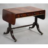 A Regency rosewood and simulated rosewood sofa table with boxwood line inlaid borders, the frieze