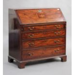 A George III mahogany bureau with crossbanded and line inlaid borders, the fall flap inlaid with