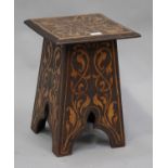 An Art Nouveau pokerwork occasional table, the square top and arched supports with overall scrolling