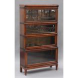 An early 20th century mahogany Globe Wernicke four-section glazed bookcase, raised on shaped