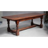 A 20th century oak refectory table, raised on turned and block legs, height 76cm, length 229cm,