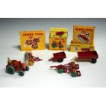 Five Dinky Toys farm implements, comprising a No. 301 Field-Marshall tractor, a No. 319 Weeks farm