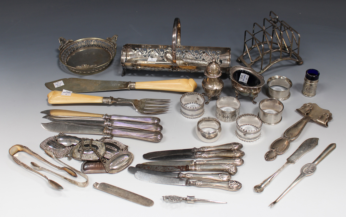 An Edwardian silver four-division toast rack with arched rectangular base and ball feet, Sheffield