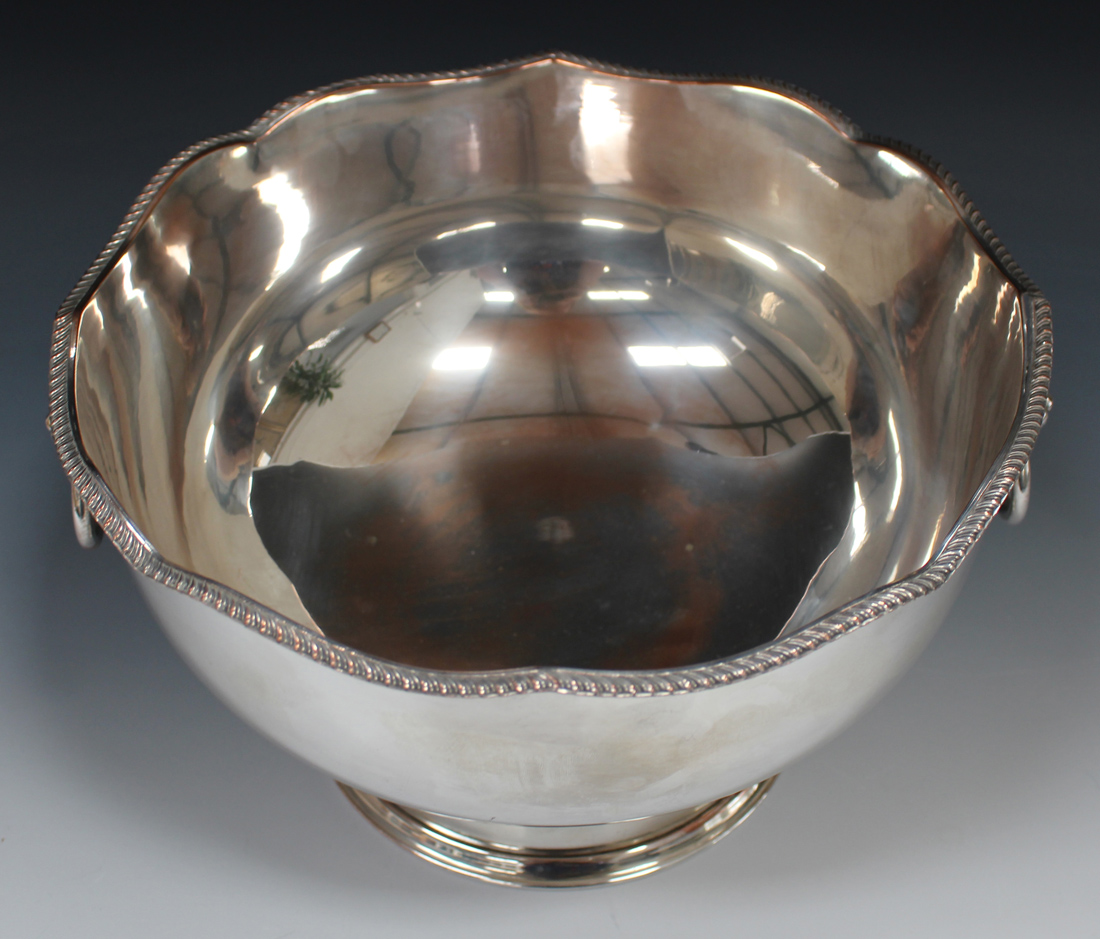 A 20th century plated punch bowl with serpentine shaped rim, flanked by two lion mask ring - Image 2 of 2