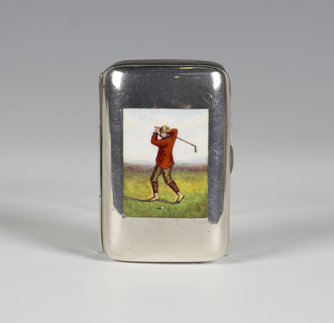 A late Victorian silver and enamel rectangular cigarette case, the hinged front enamelled with a