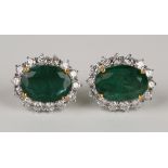 A pair of 18ct white gold, emerald and diamond cluster earrings, each claw set with an oval cut