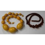 A Bakelite bead single row necklace, circa 1930s, of graduated oval honey-coloured simulated amber