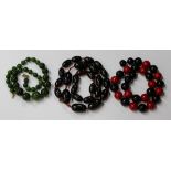 Three Bakelite bead single row necklaces, circa 1930s, one of mottled green graduated spherical