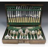 A George V plated part canteen of cutlery, comprising eight table knives and forks, four