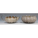 A late 19th century Indian white metal cream jug with snake handle and sugar bowl, each of lobed