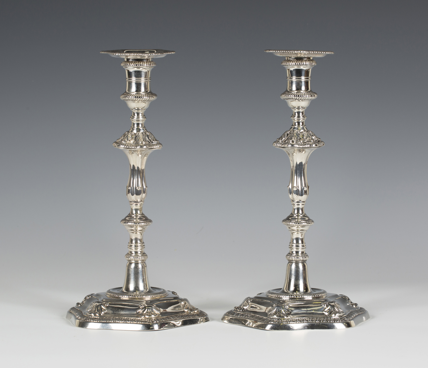 A pair of George III silver candlesticks, each with detachable sconce above a baluster stem and