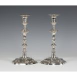 A pair of George III silver candlesticks, each with detachable sconce above a baluster stem and