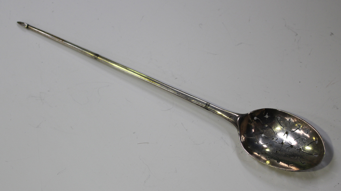 A mid-18th century silver mote spoon with tapered handle and pyramid terminal, the bowl pierced with