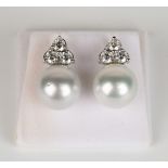 A pair of 18ct white gold, South Sea pale grey pearl and diamond earrings, each pearl mounted with a