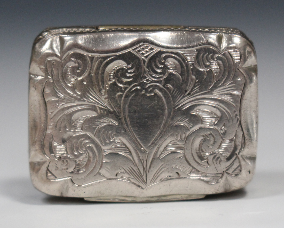 A Victorian silver vinaigrette of rectangular form with engraved scroll decoration, the hinged lid
