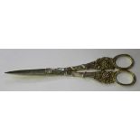 A pair of early Victorian silver gilt grape scissors, the ribbon bound reeded handles with