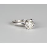 An 18ct white gold and diamond single stone ring, claw set with a circular cut diamond, ring size