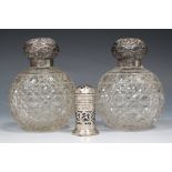 A pair of George V silver topped cut glass globular scent bottle, each screw top with embossed