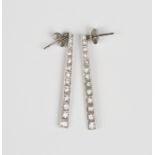 A pair of Art Deco white gold and diamond pendant earrings of tapering form, each mounted with a row