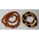 A Bakelite bead single row necklace, circa 1930s, of graduated oval pale butterscotch coloured