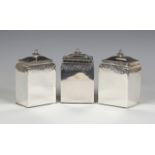 A set of three George III silver graduated tea caddies of rectangular form, each cover with flower