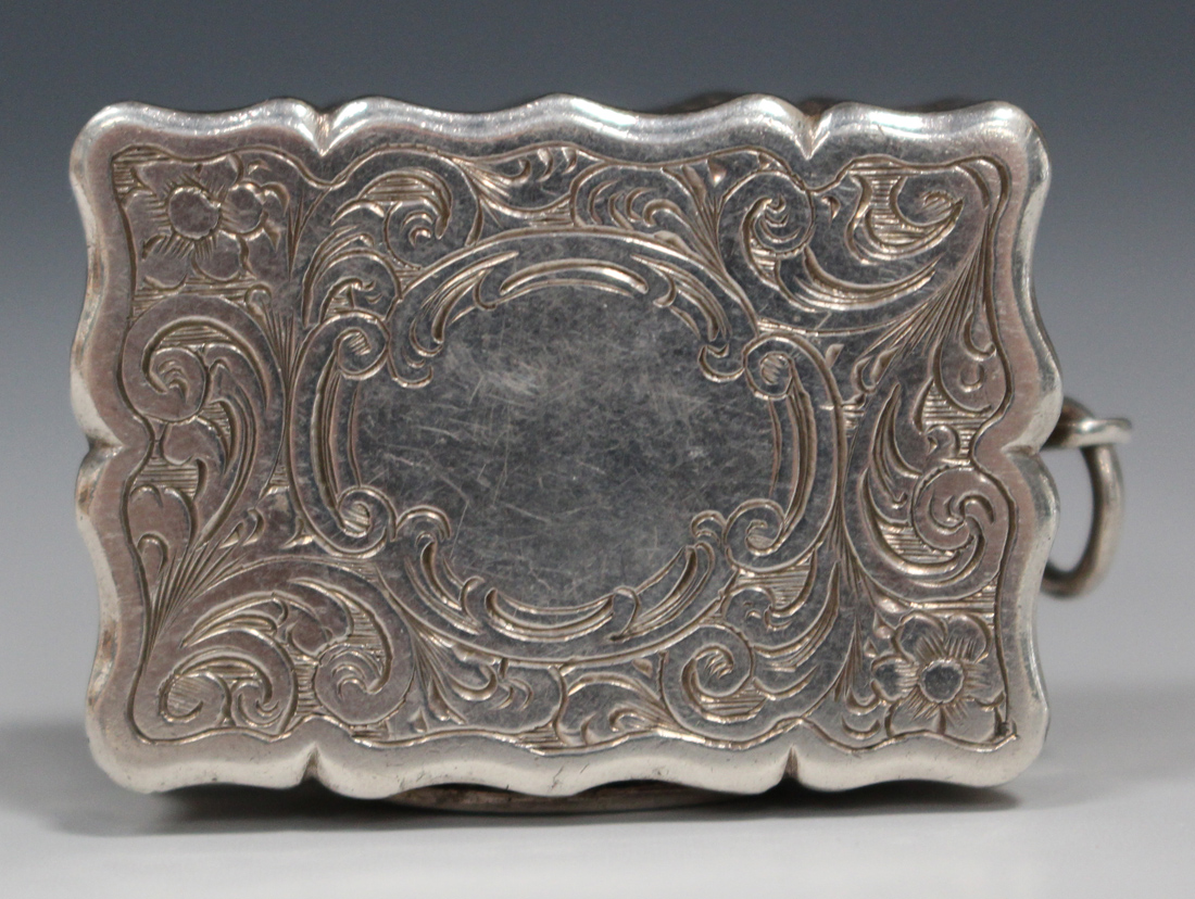 A Victorian silver rectangular vinaigrette, with overall engraved foliate scroll decoration within a